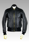 Black leather jacket with gold zipper on a mannequin against a gray background